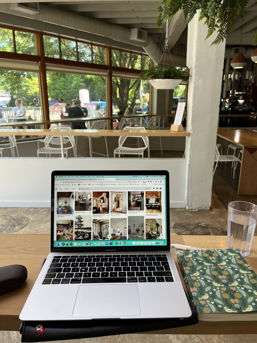 Laptop open at a coffee shop table